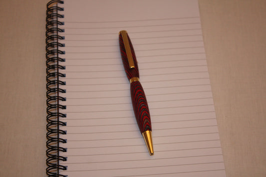Stylo artisanal en lamelles de bois teintées et collées entre elles avant d'être coupées en diagonale. Le fait de couper les lamelles en diagonale lui donne cet aspect si particulier et si joli une fois la fabricaton terminée. Ce stylo a une écriture noire.