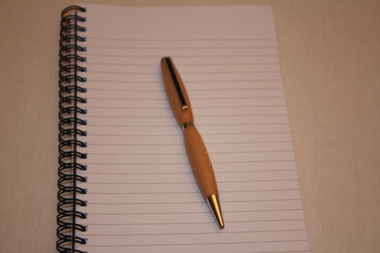 Stylo bille en platane fabriqué de façon artisanale. La couleur d'écriture de ce stylo est noire.  