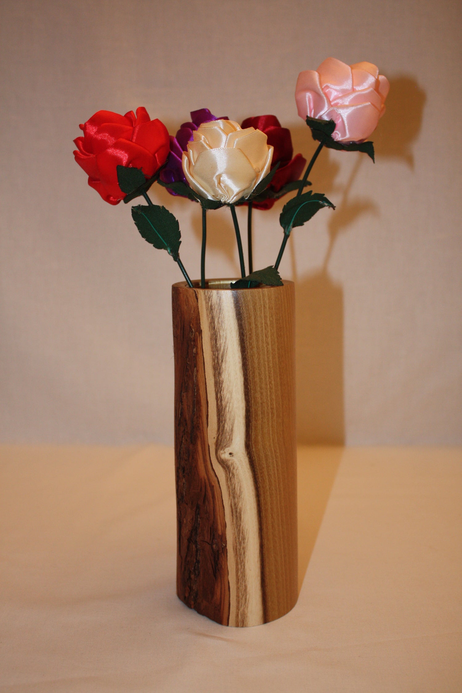 Vase en bois d'acacia avec écorce. A l'intérieur du vase se trouve un verre ce qui permet d'y ajouter de l'eau. C vase fait 22 cm de haut.